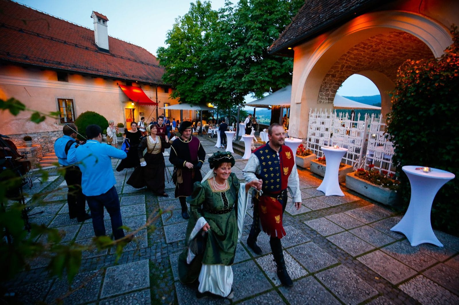 Costumed hosts welcoming guests on the terrace of Bled Castle